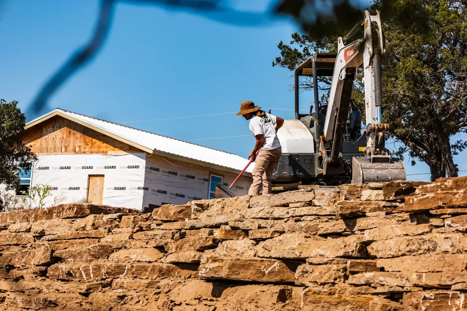 Crew setting stacked limestone